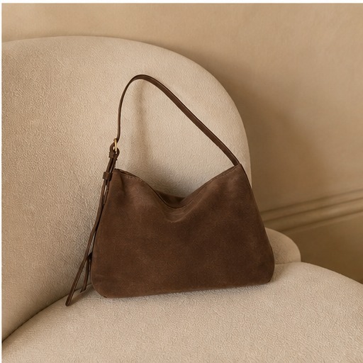 Brown CADRIVAS shoulder bag styled on a cream chair